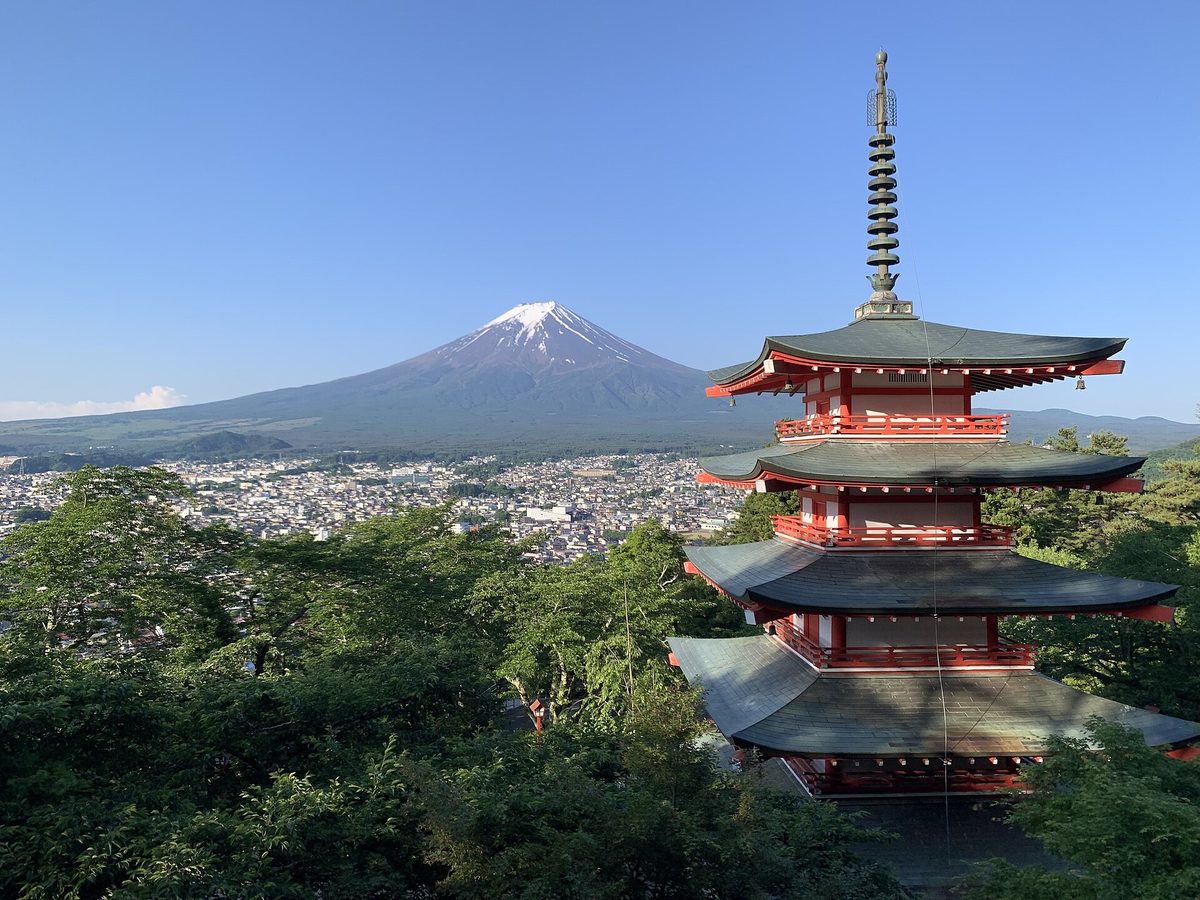 Snow-capped Mt. Fuji behind a five-story red pagoda