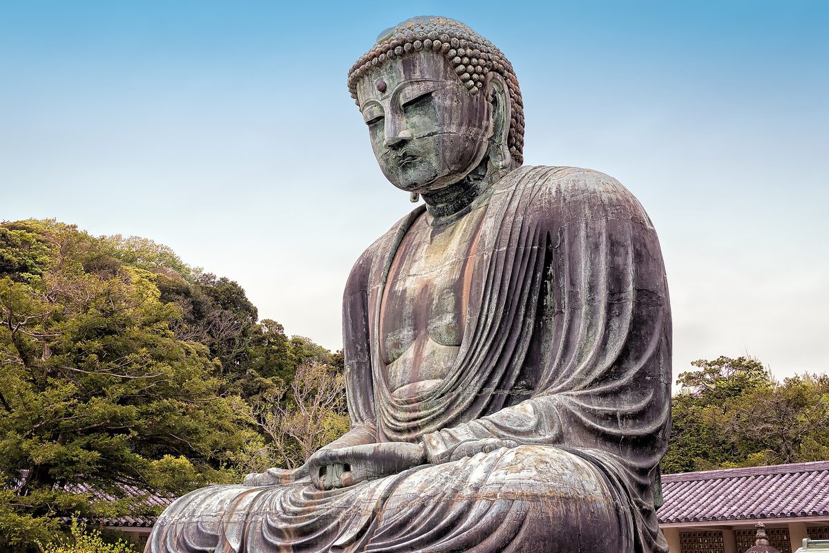 The great bronze Buddha statue seated against a blue sky