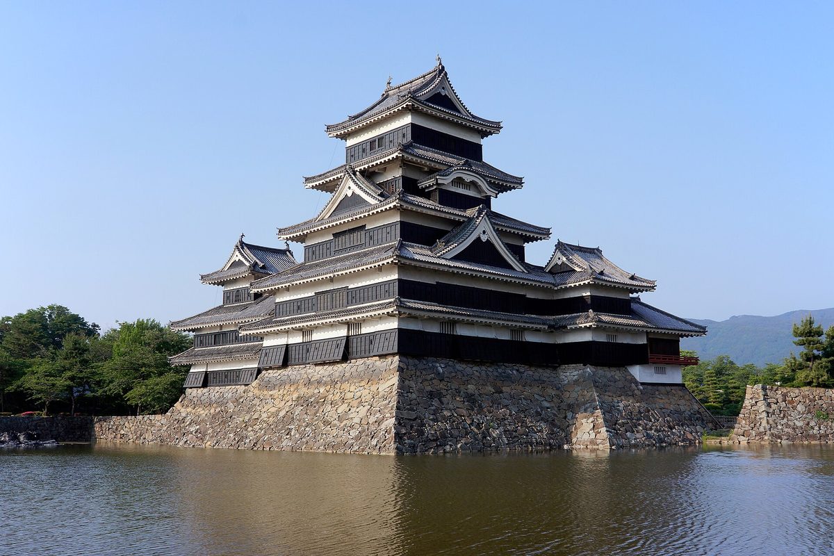 The black main keep of Matsumoto Castle reflected in its moat
