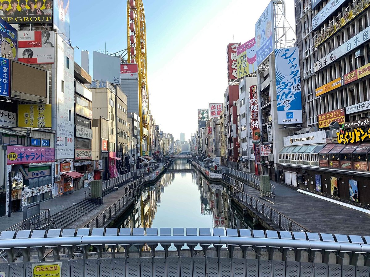 The Dotonbori canal lined with signboards on a clear day