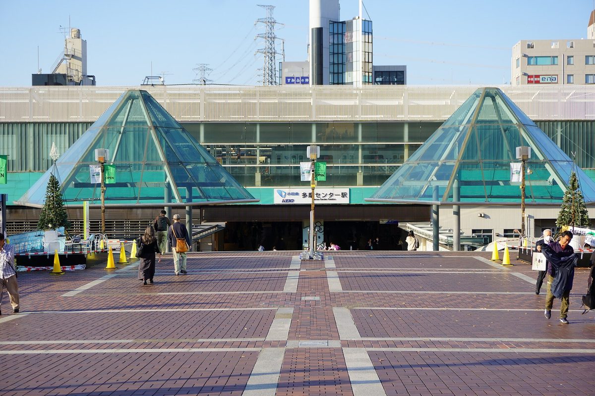 The plaza in front of a station with two glass pyramid roofs